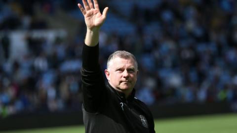 Mark Robins waves to the Coventry fans 