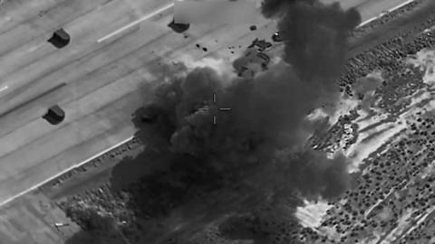 A black and white thermal imagery screengrab showing a US strike on a target in Iran.