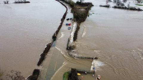 A photo of cars stranded in floodwaters