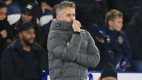 Ipswich boss Kieran McKenna covers his face with his jacket collar