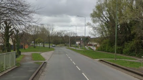 Birch Green Road: a long road with trees and greenery on either side.