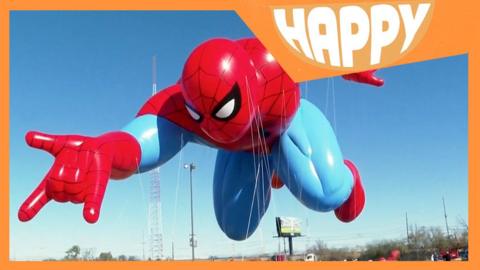 A giant Spider-Man balloon and the Happy News logo