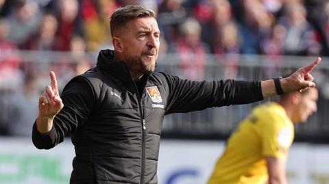 Northampton Town boss Jon Brady on the touchline during a recent game