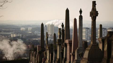 A row of graves at the Necropolis cemetery, which is on top of a hill, with the city lying behind and below