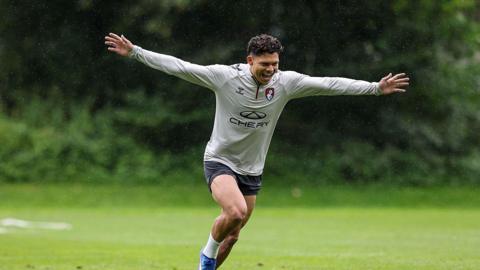 Evanilson smiling and celebrating a goal in Bournemouth training with his arms outstretched