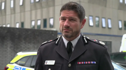 Then acting chief constable of Devon and Cornwall Police Jim Colwell. He is stood in his uniform outside Crownhill Police station.