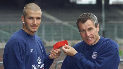 England caretaker manager Peter Taylor handing the captain's armband to David Beckham in 2000