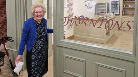 Doreen outside the care home's Thorntons shop