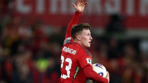 Nathan Broadhead runs holding the ball after scoring for Wales