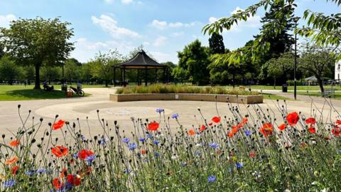 A bed of flowers in front of the coronavirus memorial in Gloucester Park