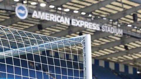 A shot of the goals posts and a sign bearing the name of the Amex Stadium in Brighton before the Premier League match against Tottenham
