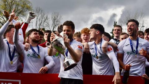 Merthyr players celebrate their title win