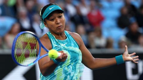 Naomi Osaka hits a forehand