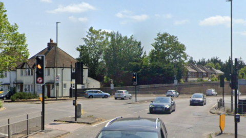 A Google Map image of a road junction with cars.