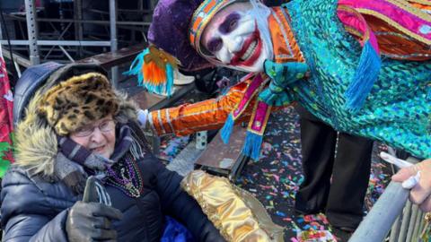 Avril Davidge posing with a character at the Mummers Parade