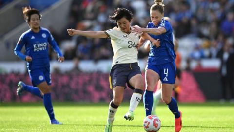 CJ Bott and Honoka Hayashi battle for the ball