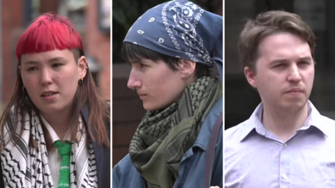 Three people - a woman with brown hair died red at the top and a black and white scarf, a woman with black hair and a blue head scarf and a man with brown hair and a pale shirt