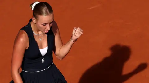 Anastasia Potapova celebrates with a clenched fist