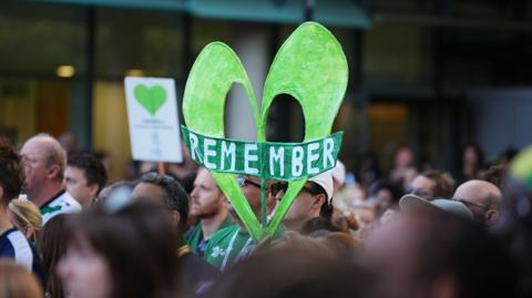 People take part in a silent march in west London in memory of those killed in Grenfell Tower.