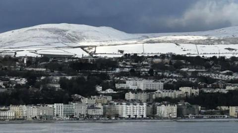 You can see buildings on the prom, you can see snow on the hills in the background.