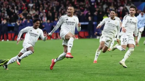 Real Madrid players celebrate winning the penalty shootout