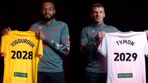 Lawrence Vigouroux and Josh Tymon hold up Swansea shirts