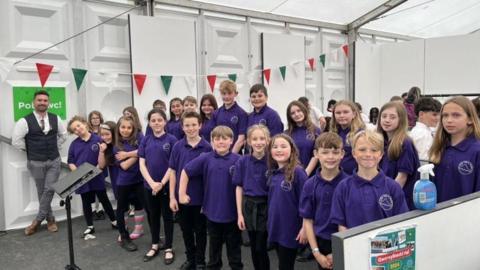 Jonny Small on the left with school children in purple t-shirts