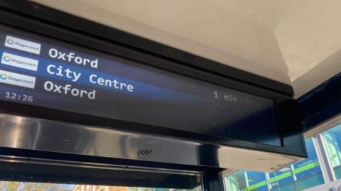 A digital display board showing the times the next buses are due