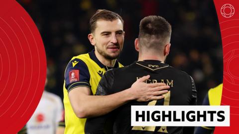 Michal Helik and Matt Ingram celebrate Oxford United's FA Cup win over MK Dons