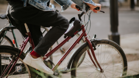A stock image of someone on a bike. Only their legs are visible.