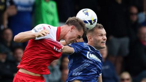 Josh Smith wins a header playing for Accrington against Gillingham