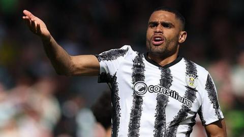 Mikael Mandron, pictured in St Mirren's black and white striped kit, raises a hand in query
