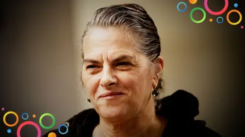 Close up of British artist Tracey Emin with her hair tied up