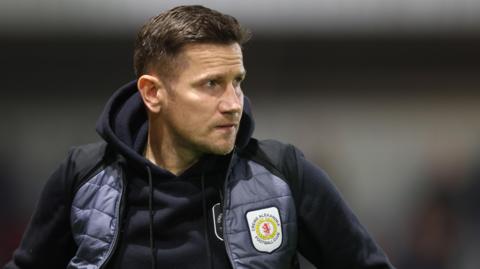 Lee Bell watches on from the touchline 