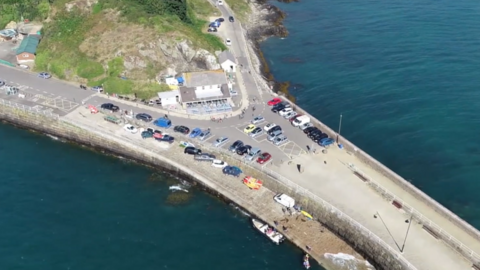 St Catherine's, where the walk will begin. There are cars parked on a slipway and sea surrounding it.