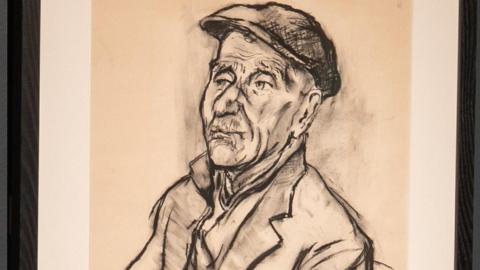 A charcoal drawing of an elderly man looking into the distance wearing a flat cap and a coat with a notched lapel.