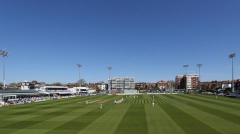 Sussex's Hove cricket ground under blue skies and players out on field in whites