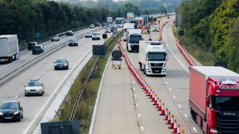 An image of Operation Brock in a previous year, which shows large trucks being directed down the opposite carriageway by red and wine traffic cones.