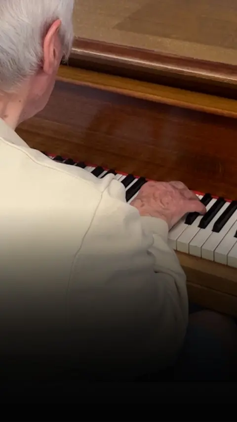Over the shoulder image of man playing piano
