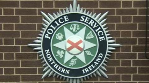 The crest of the PSNI hangs on a police station wall