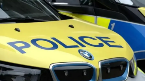 A close up of a police car. It is a BMW with the word POLICE written across the bonnet.