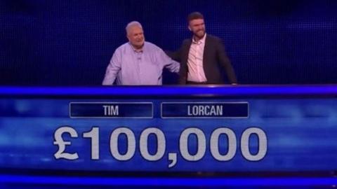Tim McCarthy and Lorcan Thorpe appear on The Chase. They are standing in the studio on the blue set behind a screen that shows their names and the prize money of £100,000.