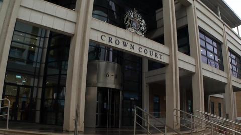 Exterior shot of Kingston Crown Court, a white concrete building