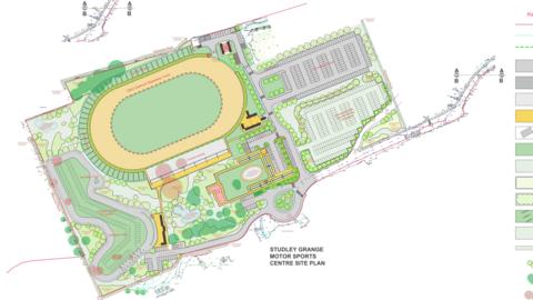 The site plans for the motorsports hub. It is an aerial map of the site, which includes a large racing track to the centre, top of the site, with numerous parking spots to the right.