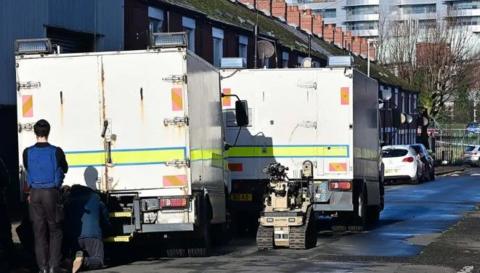 Army Technical Officer vehicles and robot pictured on a street 