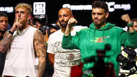 Jake Paul shushes the crowd as Julio Cesar Chavez Jr flexes 