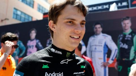 McLaren driver Oscar Piastri smiles as he arrives in Monaco for the 2025 Grand Prix
