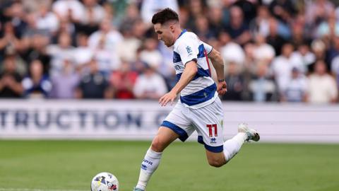 Paul Smyth running with ball at speed wearing home blue and white hoops