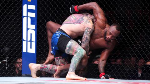 Leon Edwards wrestles with Sean Brady