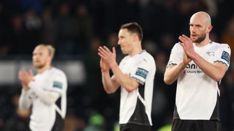 Matt Clarke claps his hands during his first match back at Derby